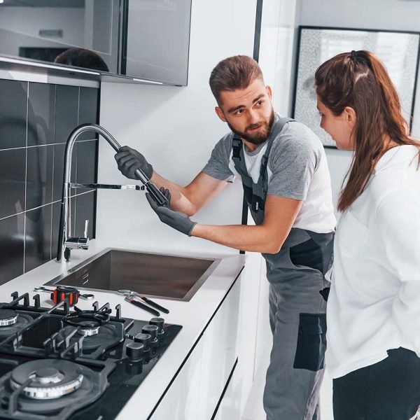 young-professional-plumber-in-grey-uniform-shows-r-resize.jpg Plumbers in St George UT